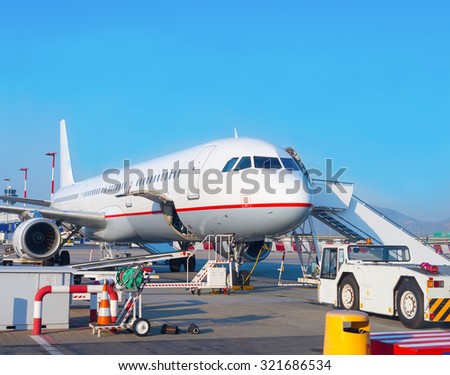 Passenger plane in the airport. Aircraft maintenance.