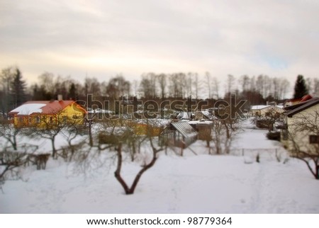 Winter. Cottage village with tilt shift lens effect.