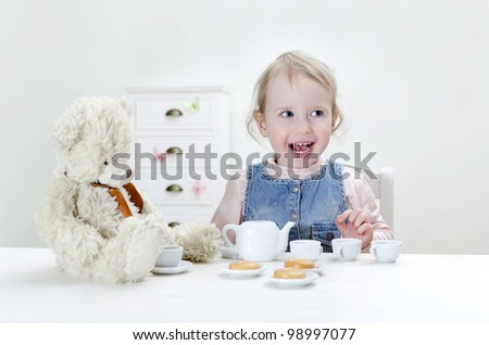 Child drink tea with bagels at home.