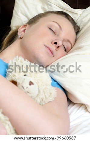 Young girl fell asleep with teddy bear