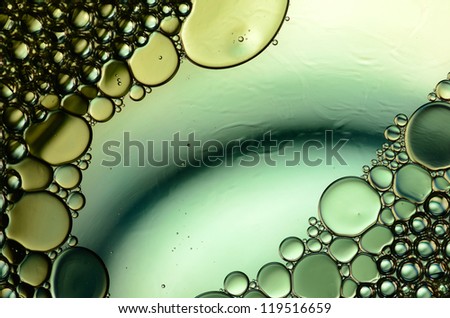 oil drops on the water surface in green