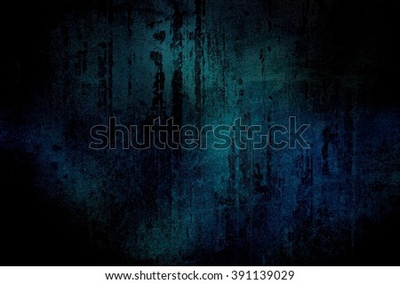 Black scratches on a dark blue-green wall. Grunge surface with cracks and scratches in the dark.
