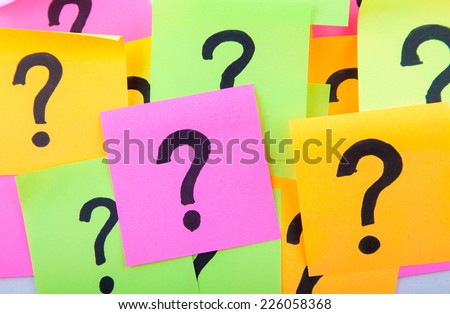 questions, decision making or uncertainty concept - a pile of colorful crumpled sticky notes with question marks
