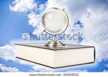 Globe on book isolated over white background