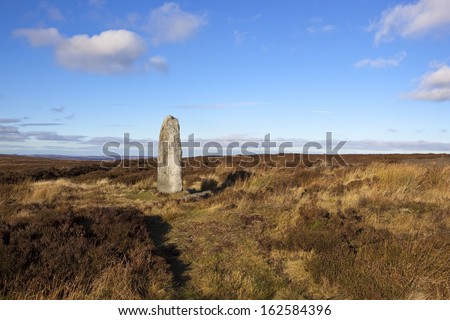 an ancient monolith standing in the bleak autumn landscape of the north york moors yorkshire england