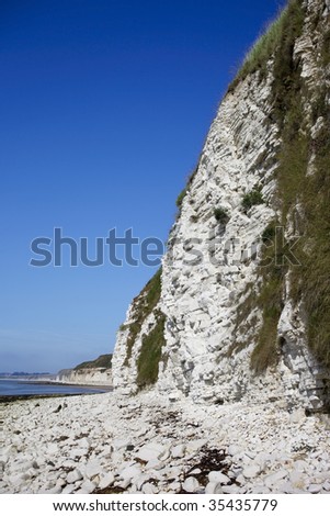 view of limestone sea cliffs under a warm blue summer sky