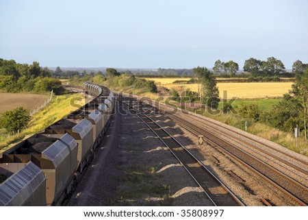 a coal train on railway tracks on a summers day