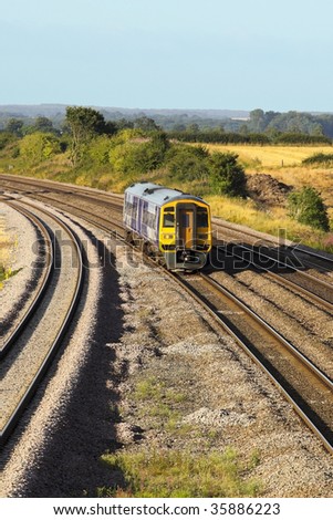 a train on a country rail track in summer