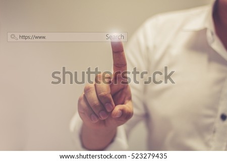 Businessman Search button on virtual touch screen  / soft focus picture / Vintage concept