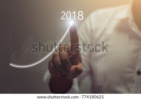 Businessman plan growth and increase of positive indicators in his business.\
Business growth concept year 2018