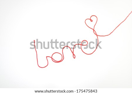 Word love made from a red string with a heart shape, white background