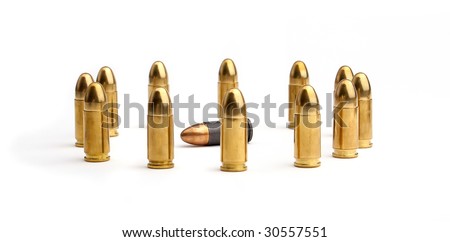 Brass bullets standing in circle around laying copper bullet