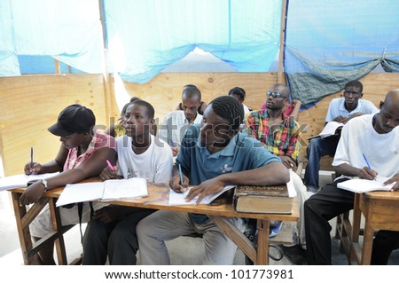 CITE SOLEIL-AUGUST 25: Students taking notes in a basic english class in a  community school in Cite Soleil- one of the poorest area in the Western Hemisphere on August 25 2010 in Cite Soleil, Haiti.