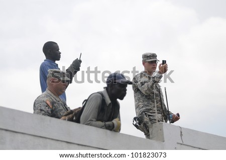 PORT-AU-PRINCE - SEPTEMBER  1:  US marines taking picture with their mobile camera of a funeral which turned into a protest on September 1 2010 in Port-Au-Prince, Haiti.