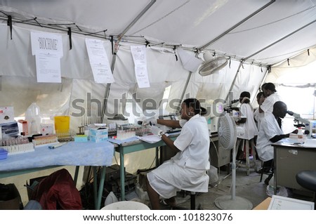PORT-AU-PRINCE - AUGUST 26:  Health workers of an hospital working under difficult condition in a makeshift tent on August 26 2010 in Port-Au-Prince, Haiti.