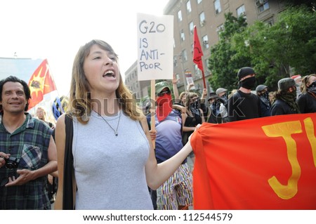 TORONTO-JUNE 25:A middle aged woman participating in a rally    during the G20 Protest on June 25  2010 in Toronto, Canada.