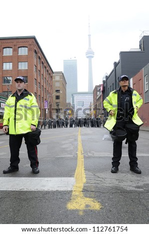 TORONTO-JUNE 26:  A  group of Toronto police officers standing in front of a perimeter formed by the riot police  during the G20 Protest on June 26 2010 in Toronto, Canada.