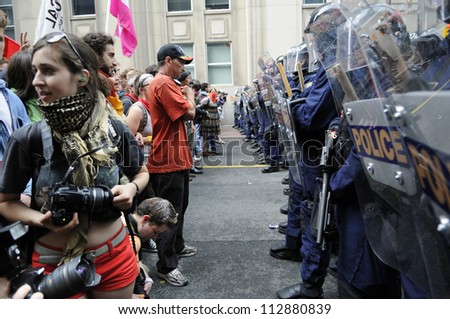 TORONTO-JUNE 26:   Protesters standing face to face with the riot police  after being not allowed to enter the summit area during the G20 Protest on June 26, 2010 in Toronto, Canada.