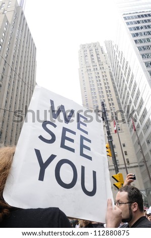 TORONTO-JUNE 27:   A protester carries a sign saying \