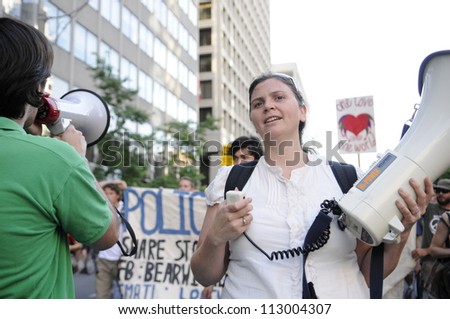 TORONTO-JUNE 28:   A woman with a megaphone  chanting slogans during the G20 Protest on June 28, 2010 in Toronto, Canada.