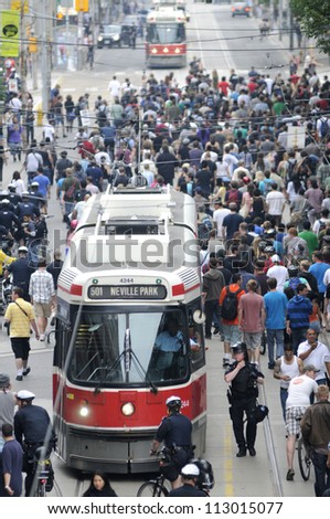 TORONTO-JUNE 28: Protesters jamming the downtown streets and restricting a passage for public transport during the G20 Protest on June 28, 2010 in Toronto, Canada.