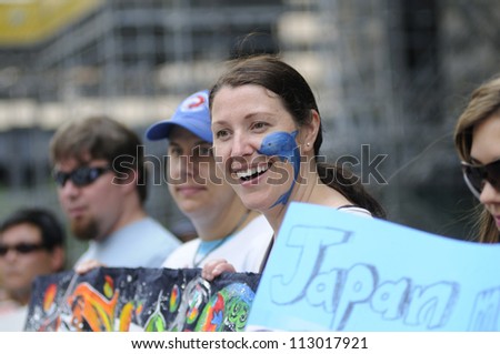 TORONTO-AUGUST 31:  Happy protesters  during a rally to protest the start of the annual  dolphin hunt at Taiji,Japan on August  31, 2012 in Toronto, Canada.