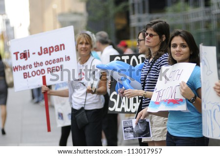 TORONTO-AUGUST 31: Protesters lining up on the sidewalks in downtown during a rally to protest the start of the annual  dolphin hunt at Taiji,Japan on August  31, 2012 in Toronto, Canada.