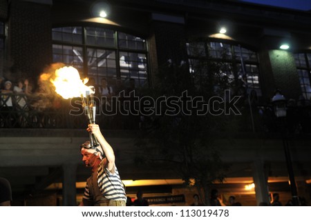 TORONTO-AUGUST 24: A street performer holds a lighted torch during the Buskerfest Festival on August 24, 2012 in Toronto, Canada.