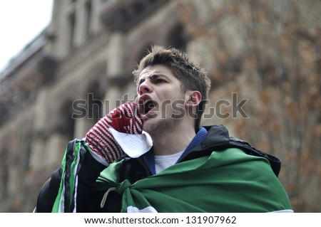 TORONTO-MARCH 16: An unidentified young Syrian chanting slogans during a protest rally organized to raise awareness and commemorate two years of Syrian revolution on March 16, 2013 in Toronto, Canada.
