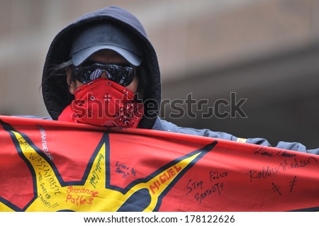 TORONTO-FEBRUARY 14: A man holding an indigenous flag during the 9th Annual Strawberry Ceremony to remember the missing and Murdered Indigenous Women  February  14 ,2014 in Toronto,Canada.