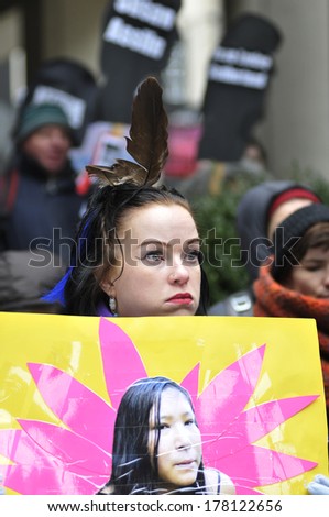 TORONTO-FEBRUARY 14: An woman holding an image of a missing woman during the 9th Annual Strawberry Ceremony to remember the missing and Murdered Indigenous Women  February 14 ,2014 in Toronto,Canada.