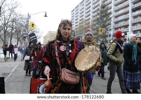 TORONTO-FEBRUARY 14: A First Nations woman walking during the 9th Annual Strawberry Ceremony to remember the missing and Murdered Indigenous Women  February  14 ,2014 in Toronto,Canada.