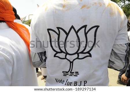 VARANASI-APRIL 24: A supporter with the BJP  with the party symbol printed on his t-shirt during a rally in his support  on April  24, 2014 in Varanasi , India.