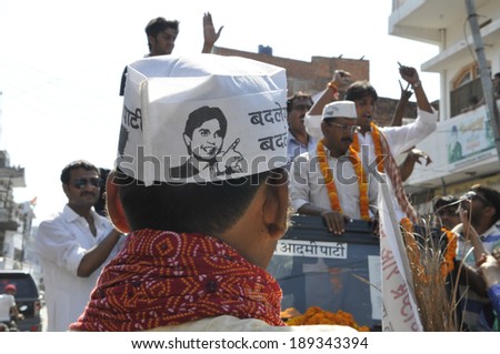 AMETHI - APRIL 20:  Supporters with AAP cap walking in front of the jeep during a road show in support of Amethi candidate Dr. Kumar Viswas on April 20, 2014 in Amethi ,India.