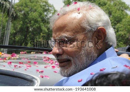 NEW DELHI-MAY 17: Indian Prime Minister Narendra Modi looking towards the waiting crowd during a roadshow after wining the Indian National election on May 17, 2014 in New Delhi , India.