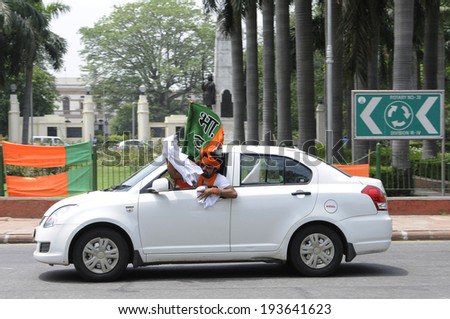 NEW DELHI-MAY 17:  A  BJP supporter distributing NAMO caps during a rally after wining the Indian National election on May 17, 2014 in New Delhi , India.