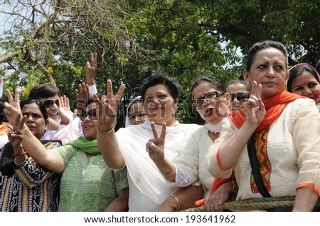 NEW DELHI-MAY 17:  Women BJP supporters chanting slogans during a bike rally after wining the Indian National election on May 17, 2014 in New Delhi , India.