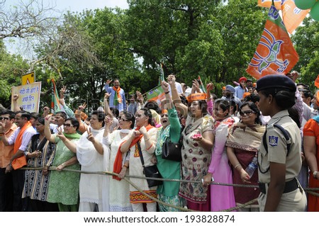 NEW DELHI-MAY 17:  Women BJP supporters chanting slogans during a rally after wining the Indian National election on May 17, 2014 in New Delhi , India.
