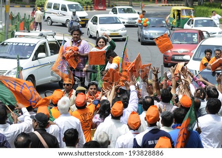 NEW DELHI-MAY 17:  BJP supporters distributing NAMO caps during a rally after wining the Indian National election on May 17, 2014 in New Delhi , India.