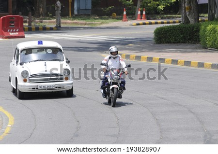 NEW DELHI-MAY 17: Security personnel coming before the  Indian Prime Minister Narendra Modi during a roadshow  after wining the Indian National election on May 17, 2014 in New Delhi , India.