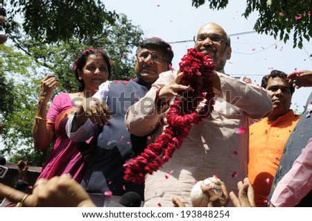 NEW DELHI-MAY 16:  Amit Shah the general secretary of the BJP party  throwing a garland towards the supporters  after BJP won the Indian National election on May 16, 2014 in New Delhi , India.