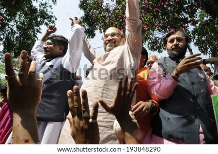 NEW DELHI-MAY 16:  Amit Shah,Ravi Shankar Prasad,Prakash Javadekar  waiving towards  by supporters  after BJP won the Indian National election on May 16, 2014 in New Delhi , India.
