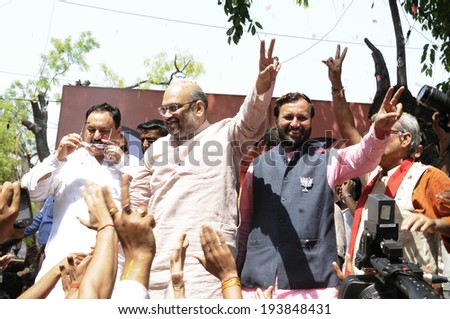 NEW DELHI-MAY 16:  Amit Shah the general secretary of the BJP party and Prakash Javadekar waiving towards the crowd  after BJP won the Indian National election on May 16, 2014 in New Delhi , India.