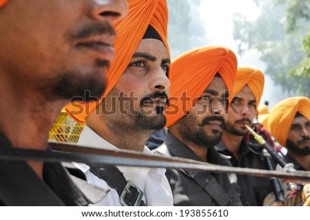 NEW DELHI-MAY 16:  A punjabi band member playing trumpet  to entertain the supporters  after  BJP won the Indian National election on May 16, 2014 in New Delhi , India.