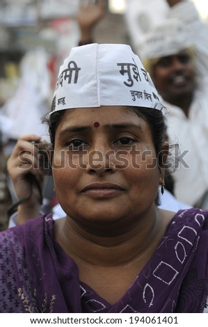 VARANASI - MAY  8:  An Indian woman with AAP cap on a motorbike  during a  AAP motorbike rally  on May  8, 2014 in Varanasi , India.