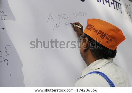 NEW DELHI-MAY 16: A supporter writing messages on a message board after BJP won the Indian National election on May 16, 2014 in New Delhi , India.