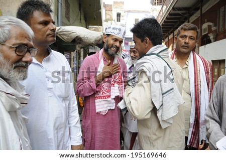 VARANASI - MAY 8: Yogendra Yadav an AAP leader talking to the voters on an early morning door to door campaign on the streets  on May 8, 2014 in Varanasi , India.