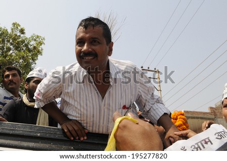 VARANASI - MAY  4 : Arvind kejriwal trying to listen to one of his supporter  during a chaotic and noisy road show on May 4 , 2014 in Varanasi , India.