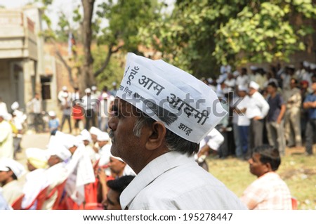 VARANASI - MAY  4 : An AAP supporter listening to the speakers during a political meeting on May 4 , 2014 in Varanasi , India.