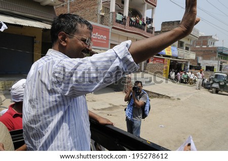 VARANASI - MAY  4 : Arvind kejriwal  waiving his hand towards his voters  during a political meeting on May 4 , 2014 in Varanasi , India.